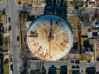 Aerial view of a rusty water tower on Long Island, New York on a sunny day