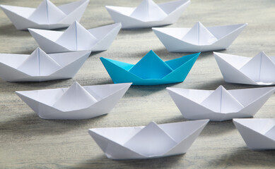 Blue and white paper boats. Business concept