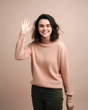 Full body studio portrait of a fictional white brunette girl waving hand. Woman in pink pullover says hello, hand gesture. Isolated on a pastel background. Generative AI illustration.