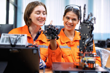 Girl engineer in robot industry fabrication research room simulate testing robot arm on operation