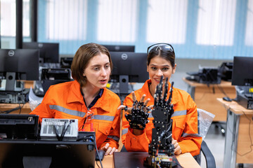 Girl engineer in robot industry fabrication research room simulate testing robot arm on operation