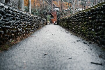 Narrow path winding through rock walls surrounded by nature empty of people