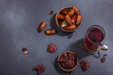 Obraz na płótnie Canvas Hibiscus hot tea with dates. Traditional Ramadan Kareem concept snack for Iftar or Suhoor meal