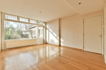 Fototapeta premium an empty living room with wood flooring and large windows looking out onto the garden area in the back yard