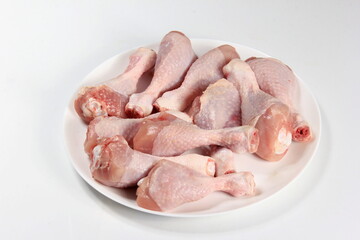 Raw chicken legs with spices on a white background, close-up. chicken drumsticks raw