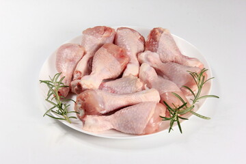 Raw chicken legs with spices on a white background, close-up. chicken drumsticks raw
