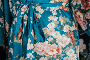 Close up on a blue japanese kimono with white flowers pattern in japanese style.