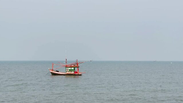 Fishing boats floating in the middle of the sea waiting to fish at Bang Lamung Sea, Chonburi, Thailand