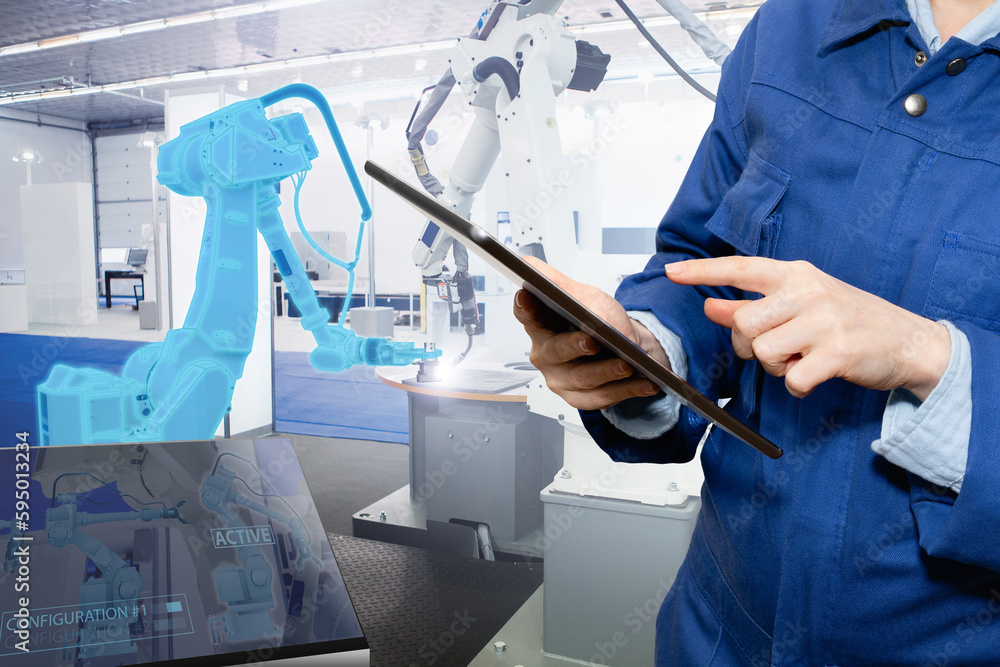 Leinwandbilder Engineer uses a digital tablet to control robots in a smart factory. Smart industry 4.0 concept	