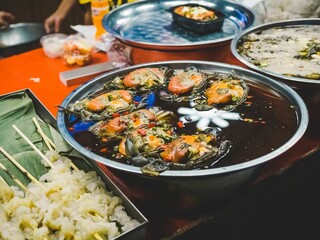 Night street food market in Bangkok, Thailand bustling with shoppers and vendors