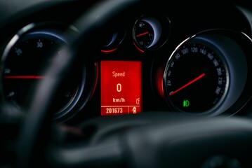 Close-up shot of a car's dashboard with a digital speedometer