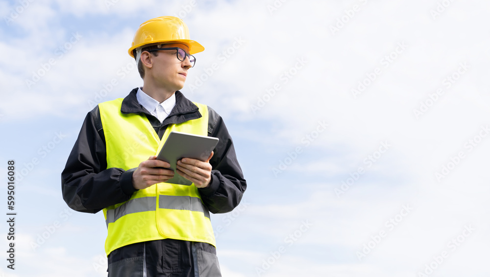 Aufkleber engineer with digital tablet on a background of blue sky
