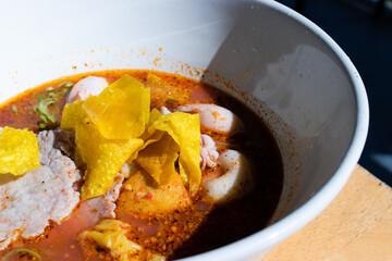 Tom Yum noodles with fish ball and minced pork - Thai style noodle.