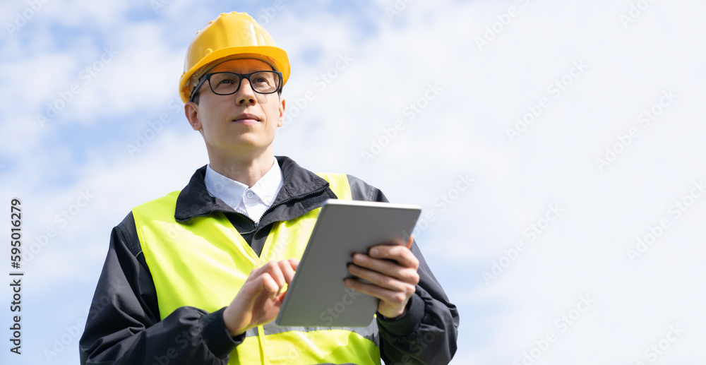 Poster engineer with digital tablet on a background of blue sky