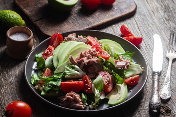 Salad with tuna, avocado and tomatoes in a bowl