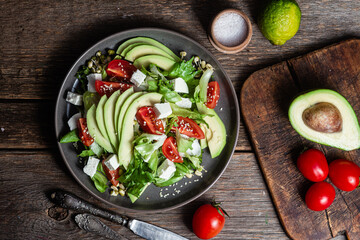 Salad with feta cheese, avocado and tomatoes in a bowl