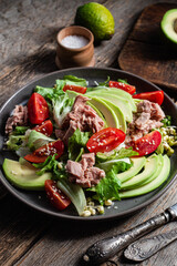 Salad with tuna, avocado and tomatoes in a bowl