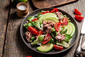 Salad with tuna, avocado and tomatoes in a bowl