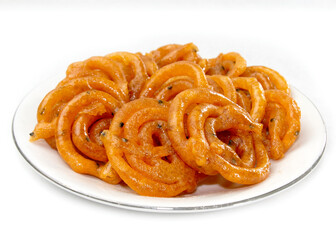 Crispy Sweet Jalebi, Jilapi, zulbia, mushabak or zalabia in white oval plate. popular in Bangladesh, India and other Asian countries.