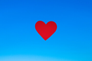 Obraz na płótnie Canvas heart shape pattern with red heart under blue sky symbolizing love