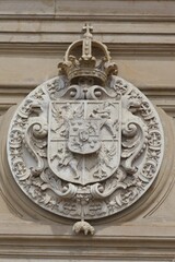 Vertical shot of the Coat of arms adorning a wall inside the Wawel royal castle, Krakow, Poland