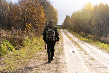 Back view of hunter with a backpack and a gun  © scharfsinn86