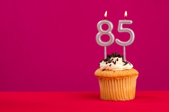 Candle number 85 - Cake birthday in rhodamine red background