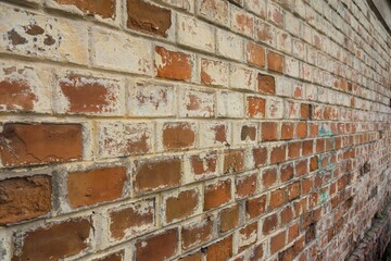 Textured brick wall featuring unique patterns in a variety of shades of brown