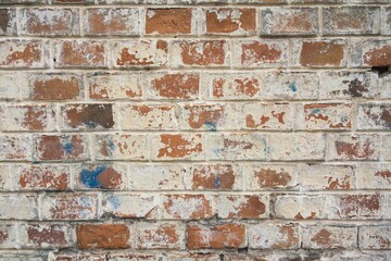 Textured brick wall featuring unique patterns in a variety of shades of brown