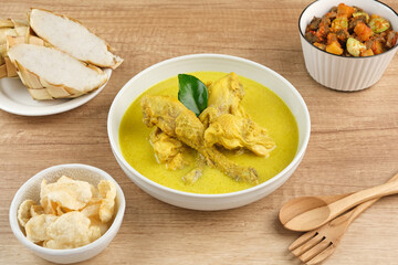 Opor Ayam, served with ketupat, sambal goreng ati, keripik kentang and emping. Popular during Eid al Fitr. Indonesian traditional food
