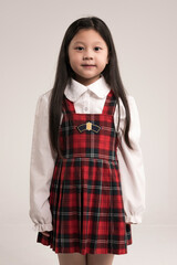 portrait of a little girl standing over white background.