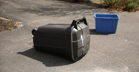 overflowing trash can next to recycling bins symbolizes the importance of proper waste management...