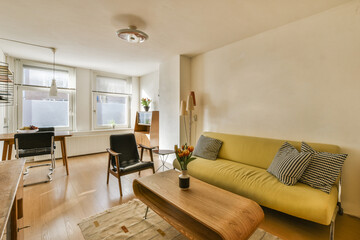 a living room with a couch, coffee table and television set in the corner on the wall is painted white