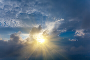 Obraz na płótnie Canvas sparkle sun push through dense cumulus clouds, dramatic sunny sky background