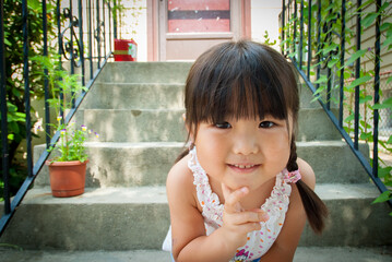 Young asian girl with long black hair smiling at the camera
