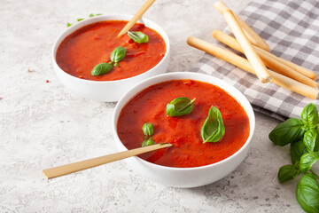 tomato and bell pepper vegetarian soup on gray background