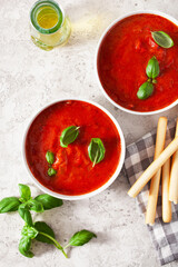 tomato and bell pepper vegetarian soup on gray background