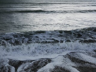 Majestic wave traveling through a vast body of water, creating a beautiful scene