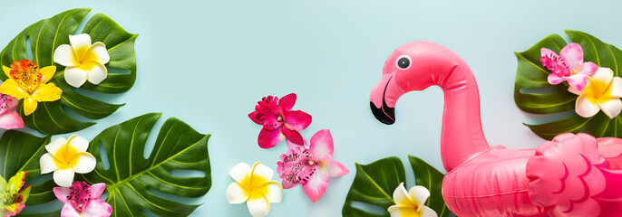 Pink flamingo, tropical leaf monstera and orchid flowers on light background. Summer beach party...