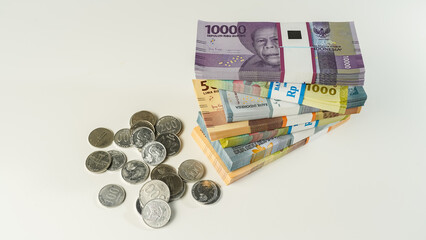 Jakarta, Indonesia, April 15, 2023, various bundles of banknotes, and Indonesian rupiah coins denominated in IDR, thousands thr zakat