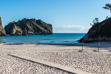Beach with mountains and wooden walkway
