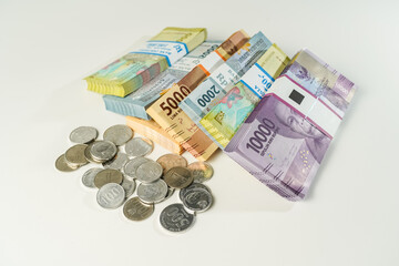 Jakarta, Indonesia, April 15, 2023, various bundles of banknotes, and Indonesian rupiah coins denominated in IDR, thousands thr zakat