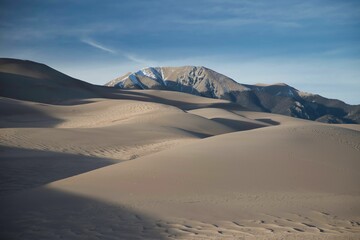 Fototapeta na wymiar Landscape of sand dunes in a desert under the sunlight