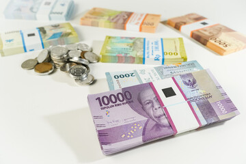 Jakarta, Indonesia, April 15, 2023, various bundles of banknotes, and Indonesian rupiah coins denominated in IDR, thousands thr zakat