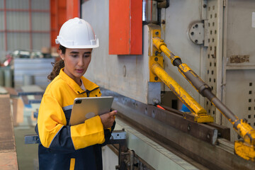 Professional heavy industry engineer worker wearing safety uniform in a metal manufacture warehouse , maintenance service check for safety first concept .