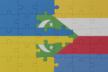 puzzle with the national flag of ukraine and comoros . macro.concept.
