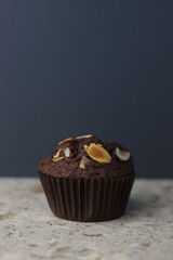 fragrant homemade
chocolate cupcake with walnuts on a dark background. for banners, postcards, napkins, flyers, business cards, screensavers, stickers, etc.