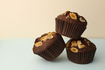 fragrant homemade
chocolate cupcake with walnuts on a light background. for banners, postcards, napkins, flyers, business cards, screensavers, labels, etc.