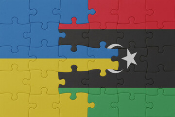 puzzle with the national flag of ukraine and libya . macro.concept.