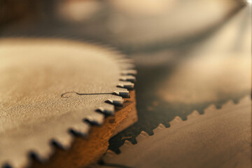Grunge image of toothed circular saw blades.